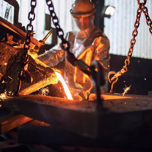 Man in a foundry with glowing material